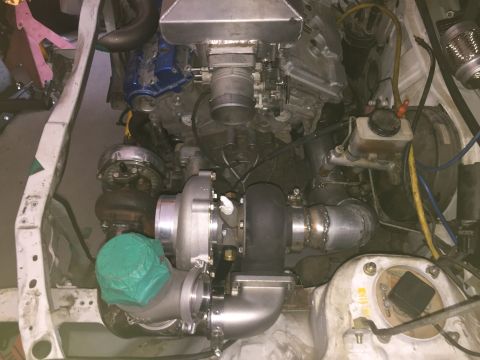 1993 Mercury Tracer - Custom twin turbo setup in an engine bay, showing complex plumbing and intercooler piping.