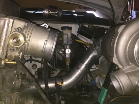 1993 Mercury Tracer - Custom turbocharger setup in an engine bay, showing intercooler piping and brake fluid reservoir.