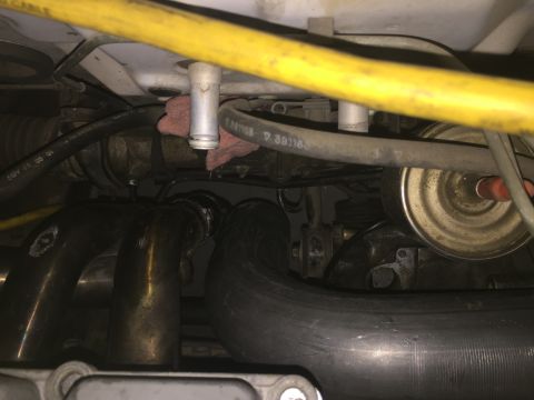 1993 Mercury Tracer - Close-up view of an engine bay, showing exhaust manifold, hoses, and other engine components.