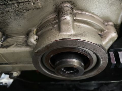 Engine block with crankshaft seal housing and threaded shaft visible. Supermotors.net logo at bottom right