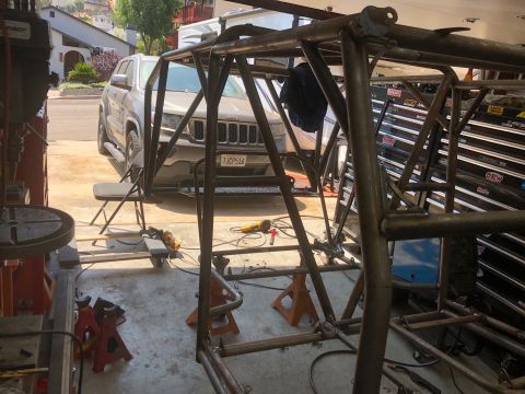 1992 Jeep Wrangler - A custom roll cage is being fabricated in a garage, with a Jeep Grand Cherokee visible in the background.