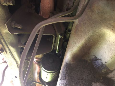 1979 Ford Bronco - Underside view of a vehicle's motor mount bracket and exhaust system components.