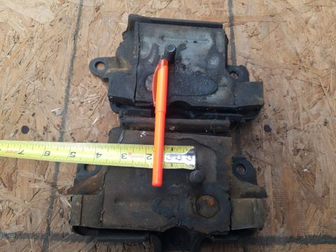 1979 Ford Bronco - Used engine mounts measured with a tape measure and pen. No year visible.