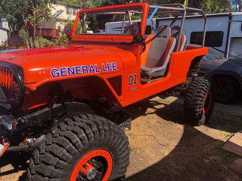1992 Jeep Wrangler - Modified Jeep CJ with 'General Lee' livery and off-road tires.