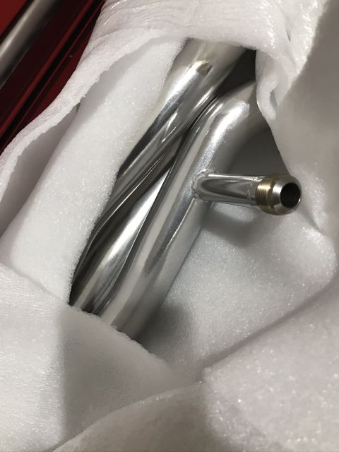 2004 Ford Crown Victoria - Close-up of polished metal pipes, likely a vehicle part, secured in protective foam packaging.