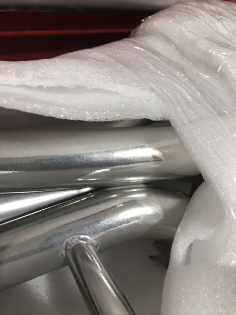 2004 Ford Crown Victoria - Chrome exhaust pipes are shown wrapped in protective packaging, obscuring any specific vehicle details.