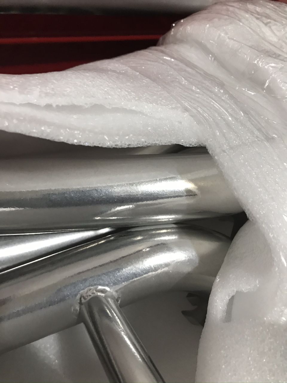Chrome exhaust pipes wrapped in protective packaging