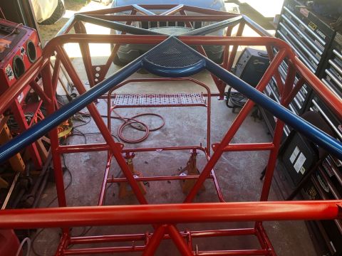 1992 Jeep Wrangler - Custom roll cage assembly being worked on in a garage setting.