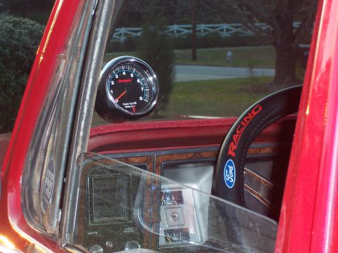 1979 Ford Bronco - Interior view of a 1979 Ford Bronco, a tachometer and Ford Racing steering wheel.