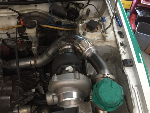 1993 Mercury Tracer - Custom turbocharger and exhaust piping installed in an engine bay.