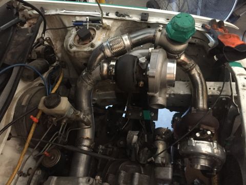 1993 Mercury Tracer - Custom twin turbo setup being installed in a vehicle's engine bay.