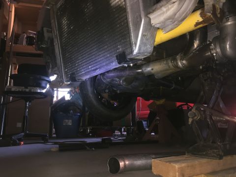 1993 Mercury Tracer - Underneath a vehicle, focusing on the radiator, exhaust system, and engine components. SuperMotors logo is present.