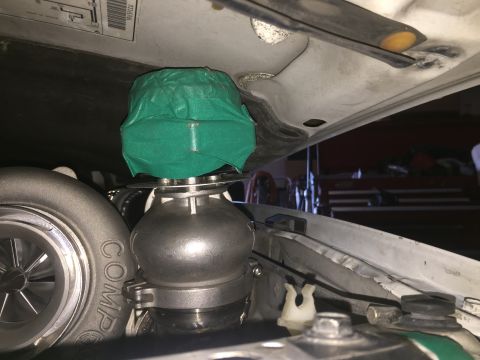1993 Mercury Tracer - Close-up of a turbocharger and a blow-off valve, with the latter covered in green tape.