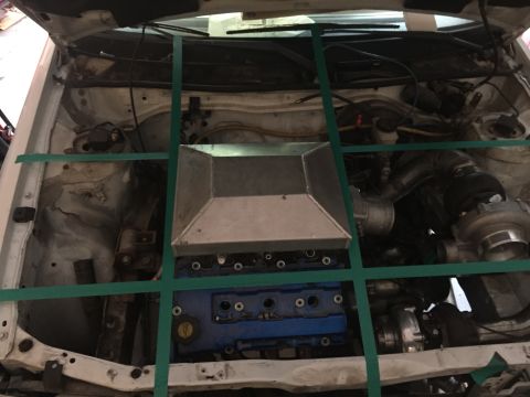 1993 Mercury Tracer - Custom intake and turbocharger installed in an engine bay, secured with green straps.