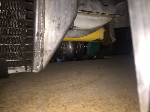 1993 Mercury Tracer - A low-angle view of a vehicle's undercarriage, revealing the radiator and other parts.