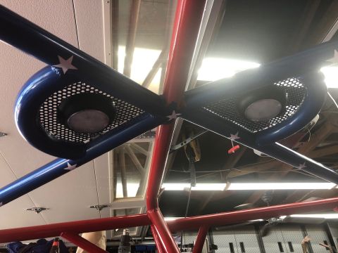1992 Jeep Wrangler - A custom roll cage, painted red and blue with white stars, features integrated speakers behind perforated grilles.