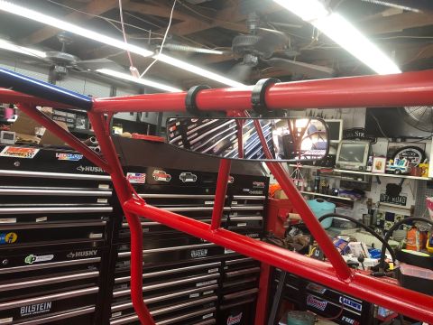 1992 Jeep Wrangler - A garage scene a red roll cage, tool chests, and various items on shelves.