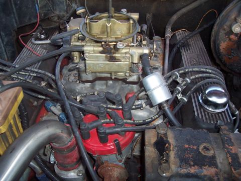 1979 Ford Bronco - Close-up view of an engine bay, highlighting the carburetor, distributor, and associated wiring.