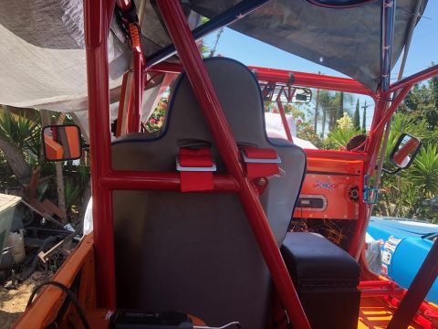 1992 Jeep Wrangler - Custom Jeep interior with roll cage and racing seats, showing aftermarket modifications and 'SUPERMOTORS' branding.