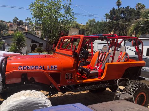 1992 Jeep Wrangler - This modified Jeep features a prominent roll cage and racing seats, with 'GENERAL LEE' and '01' graphics on the hood and fender.