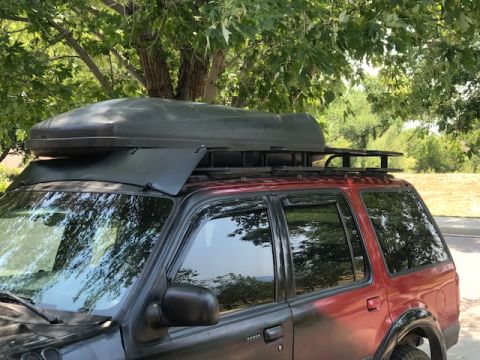 2000 Ford Explorer - 2000 Ford Explorer equipped with a roof-mounted cargo box for extra storage.