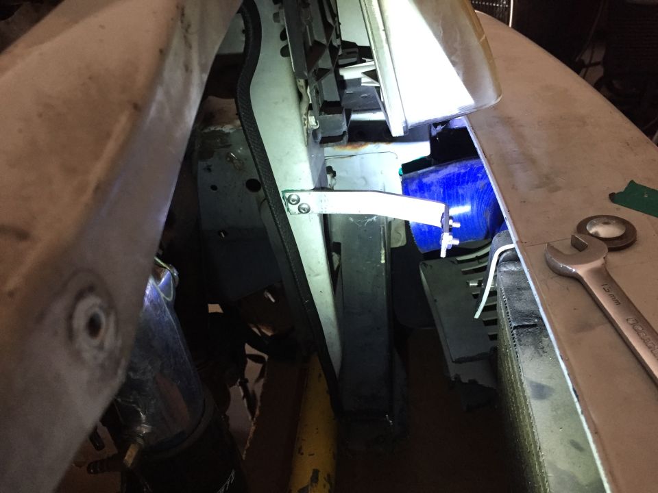 Engine bay with blue intercooler and wrench on fender