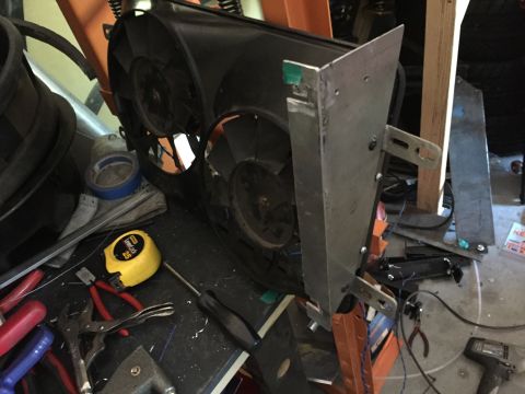 1993 Mercury Tracer - Custom bracket attached to dual radiator fans, surrounded by various tools and workshop items.