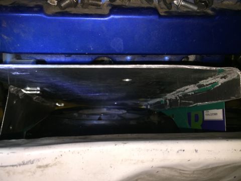 1993 Mercury Tracer - Close-up view of an engine fan and shroud, with some text visible on a green box tucked underneath.