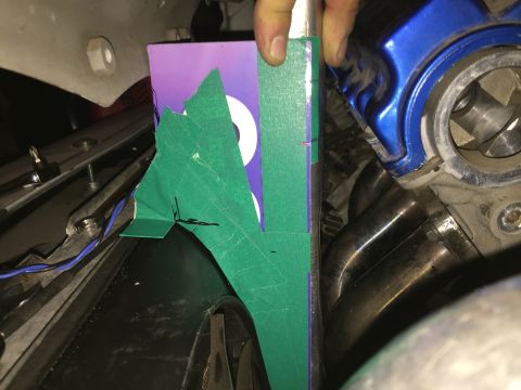 1993 Mercury Tracer - Detail of engine parts and exhaust system, with masking tape and paper for measurement or marking.