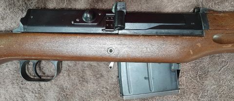 2003 Ford F-250 - A close-up view of a rifle's receiver, trigger assembly, and detachable magazine.