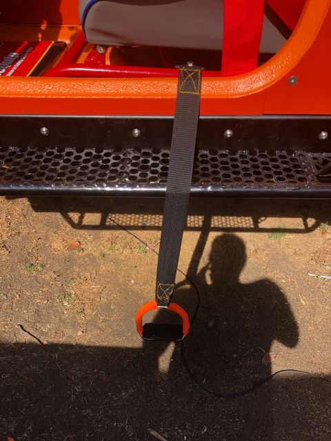 1992 Jeep Wrangler - A close-up view of a strap with an orange loop attached to the interior of a vehicle.