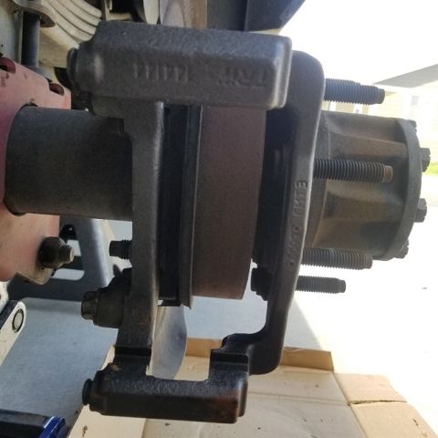 2001 Ford Excursion - Brake caliper and rotor assembly shown from the side, with visible part numbers on the caliper bracket.