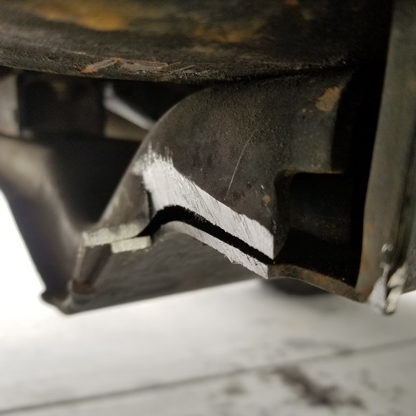Close-up of a metal vehicle frame part with a cut edge