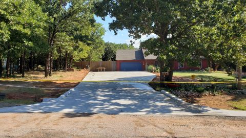 1965 Ford Mustang - Driveway construction is underway in front of a suburban home.