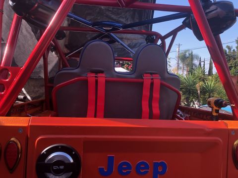 1992 Jeep Wrangler - Interior view of a modified Jeep with racing seats and a prominent roll cage structure.
