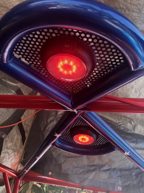 1992 Jeep Wrangler - Close-up view of red LED lights integrated into a custom roll cage, suggesting aftermarket modifications.