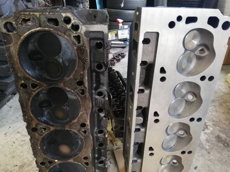 old and new engine cylinder heads side-by-side