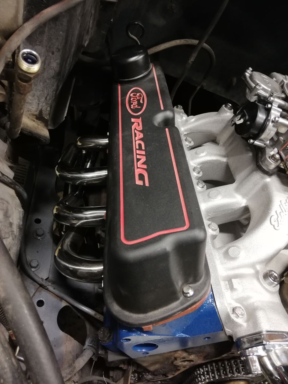 Ford Racing valve cover with red trim over engine components