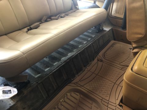 1980 Ford Bronco - Interior view of a vehicle's rear seat and floor mats, with a Supermotors.net watermark.