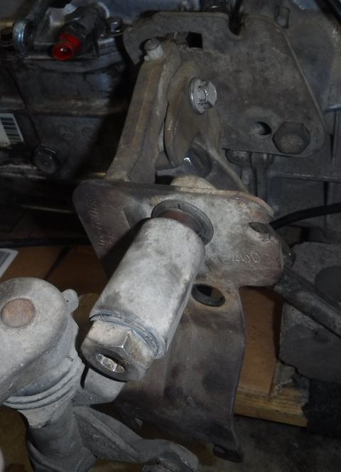 1992 Ford Bronco - M5OD t-case linkage plate bolted on, E4OD linkage plate placed in front (left bolt blocked from view by top bolt) to show alignment differe…