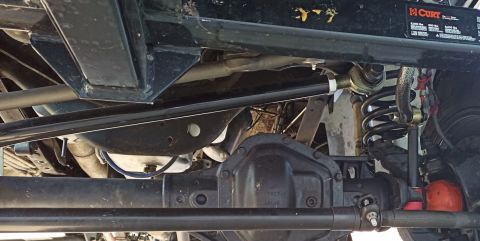 2001 Ford Excursion - Close-up of the undercarriage, focusing on the drivetrain and suspension components.