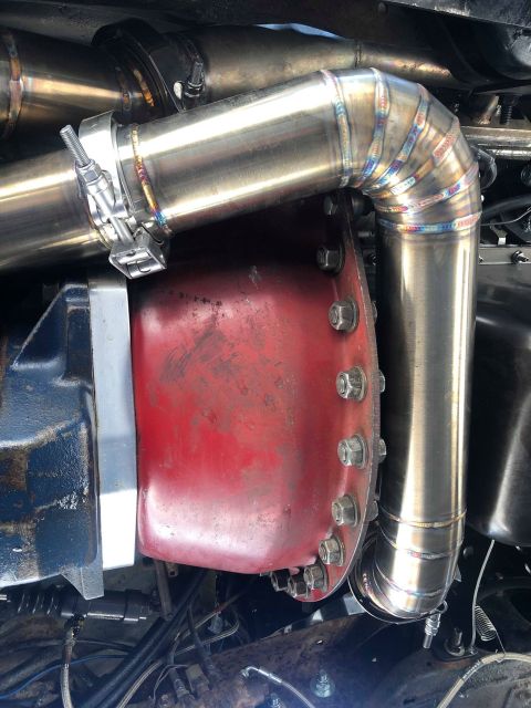 1979 Ford Bronco - Custom exhaust system installed on a vehicle's transmission housing.
