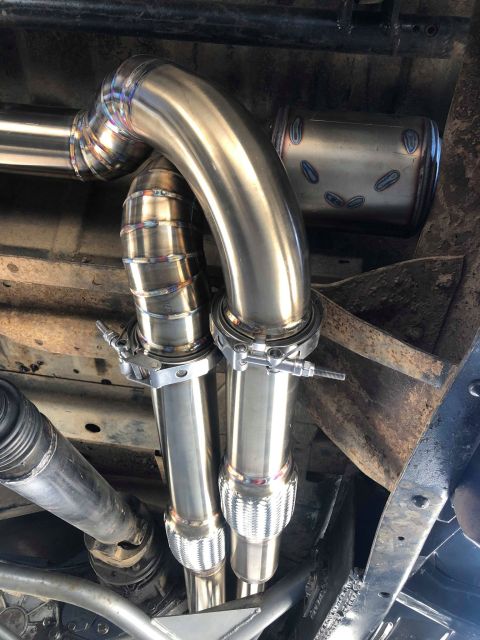 1979 Ford Bronco - Custom exhaust pipes and muffler installed on a vehicle's undercarriage.