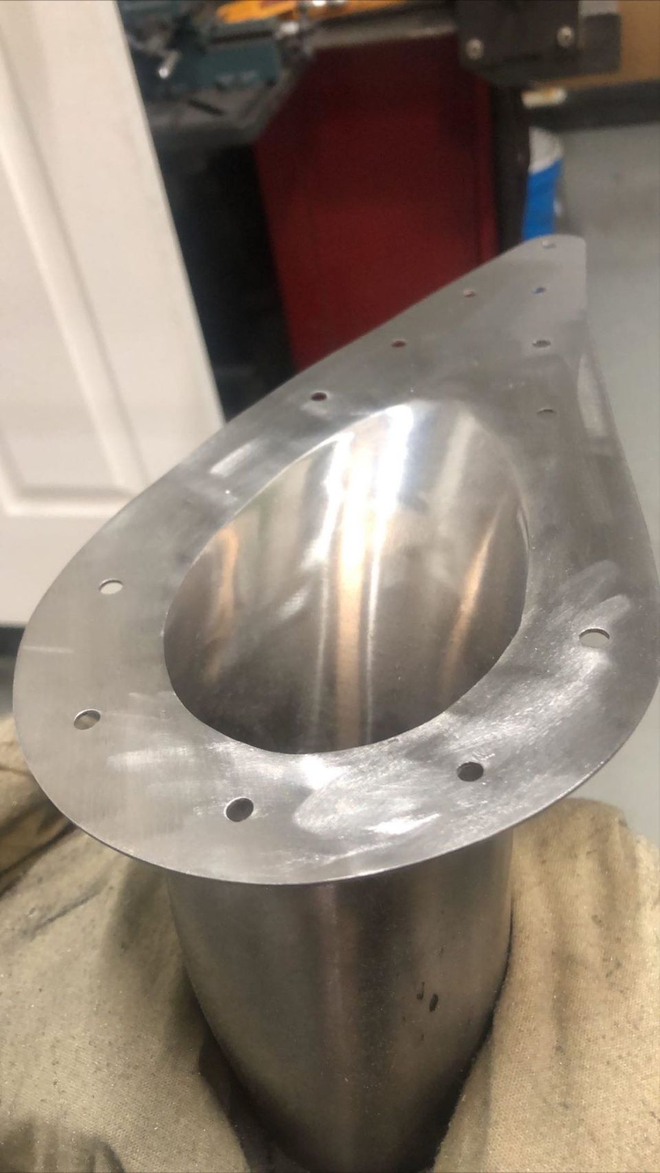 Polished metal exhaust tip with mounting holes