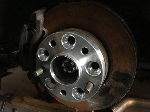 1993 Mercury Tracer - Close-up of a wheel spacer mounted on a vehicle's brake rotor.
