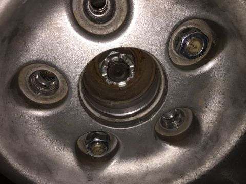 1993 Mercury Tracer - This image shows a close-up view of a vehicle's wheel hub, including the lug nuts and central fastening components.