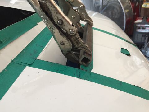 1993 Mercury Tracer - A close-up view of a car's body panel being worked on with tools and tape.