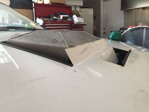 1993 Mercury Tracer - Custom hood scoop modification on a white vehicle, likely undergoing custom work.