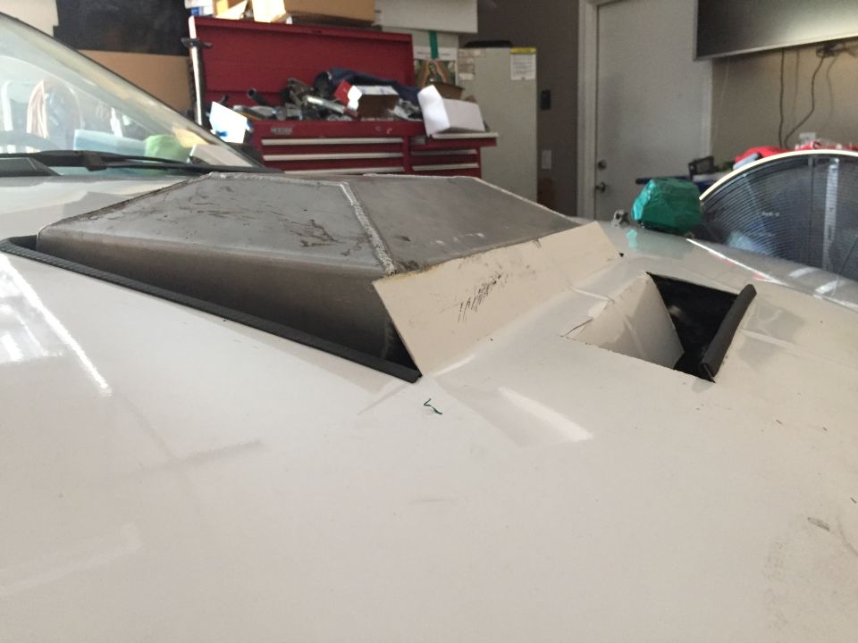 White car hood with custom metal and fiberglass scoop