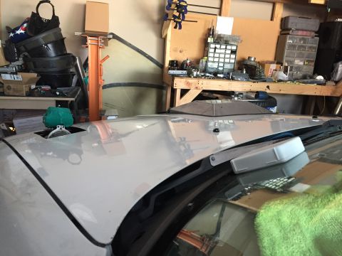 1993 Mercury Tracer - The photo shows the hood and windshield area of a car, with a cluttered garage in the background.